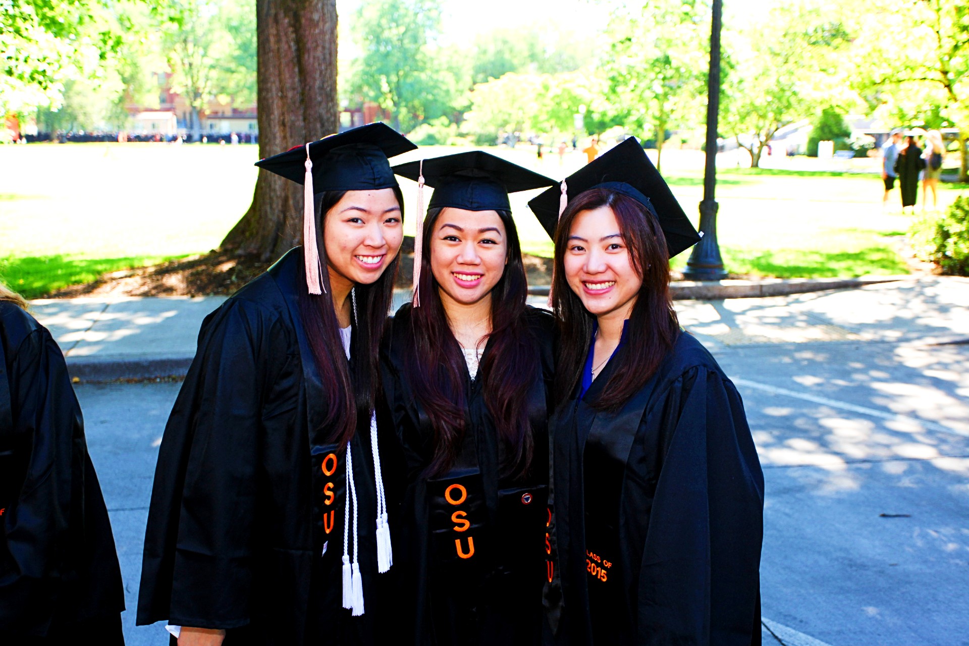 three graduates at commencement