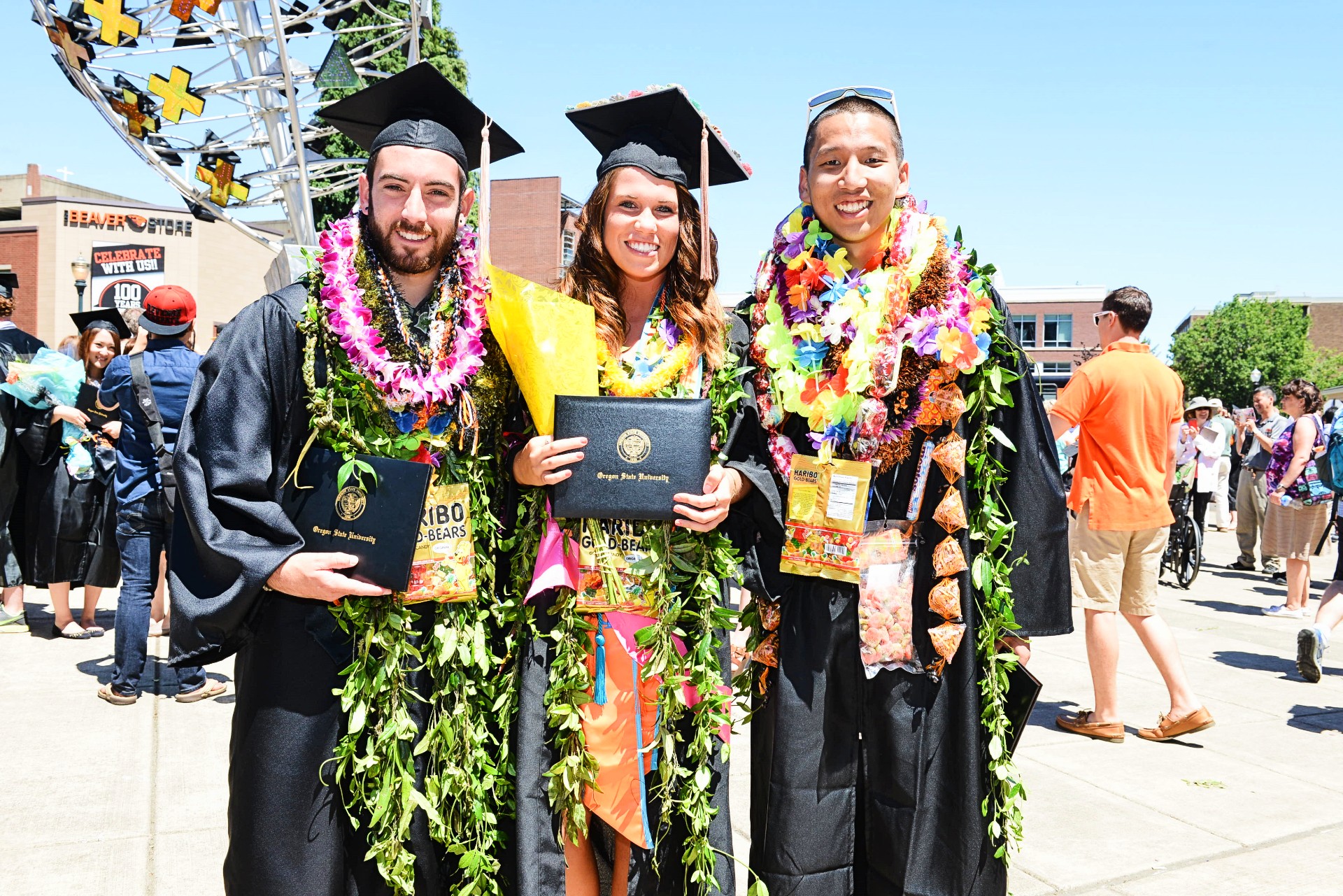 three graduates at commencement