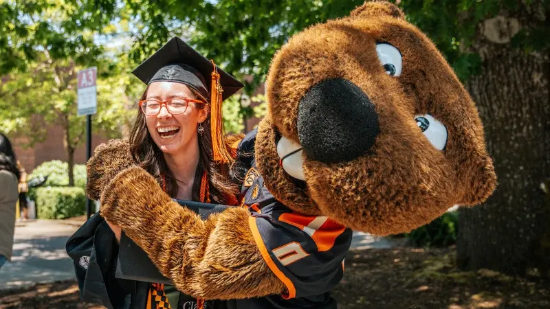 graduate being hugged by Benny