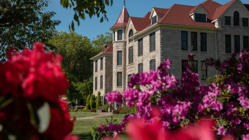 campus building framed with flowers