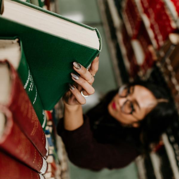 student grabbing book